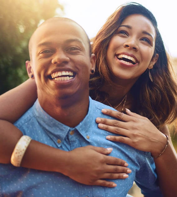 teeth whitening patient model couple smiling while hugging